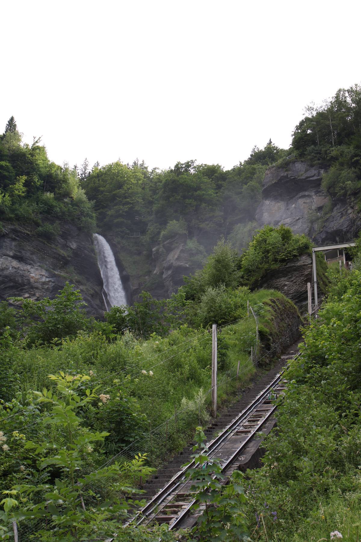 The waterfall and the train tracks are visible