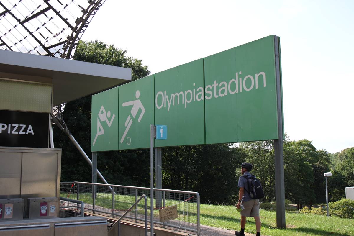 My dad walks past the Olympic Stadium sign
